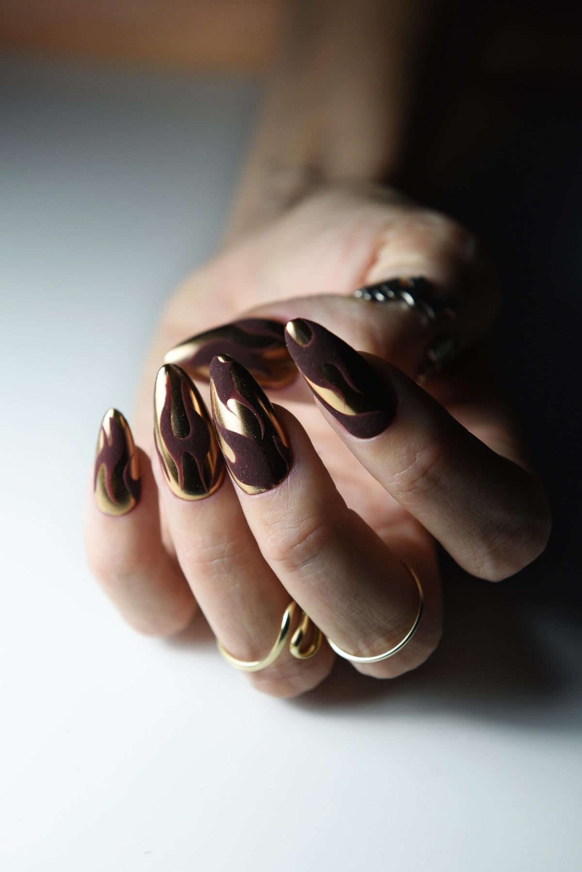 Bronze copper mirror chrome press-on nails with dark matte flame art – detail view