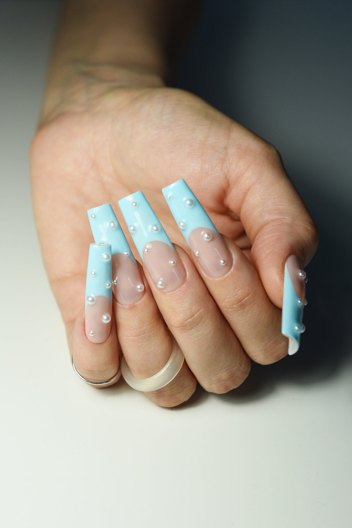 Pastel blue French long square press-on nails on hand