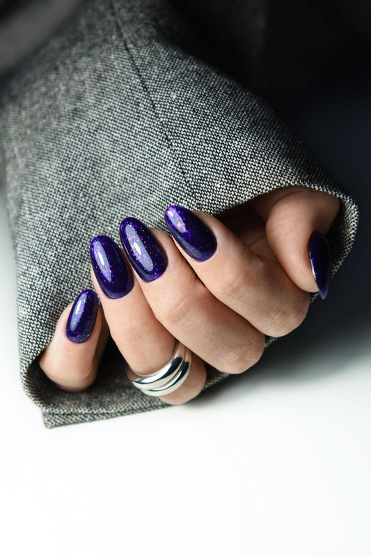 Deep violet press-on nails with subtle purple sparkle