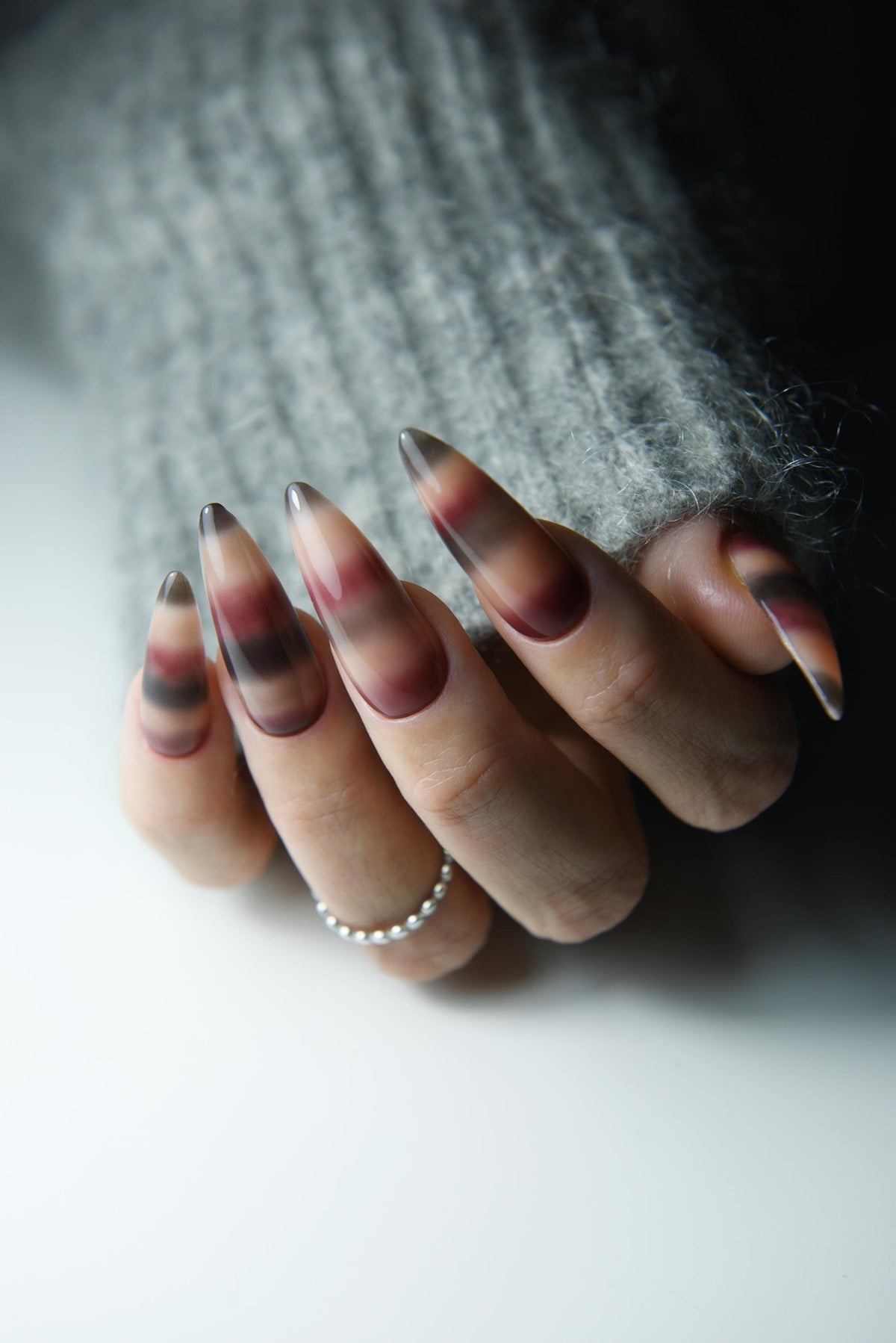 Hand-painted mohair sweater-inspired press-on nails in long almond shape – detail view