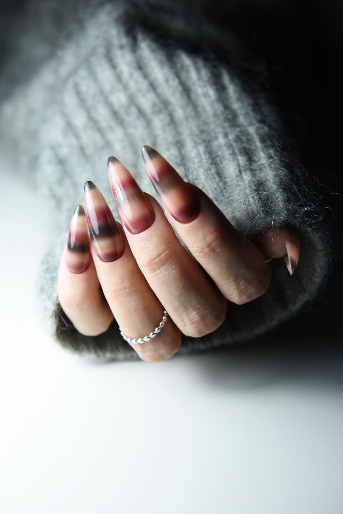 Hand-painted mohair sweater-inspired press-on nails in long almond shape – detail view