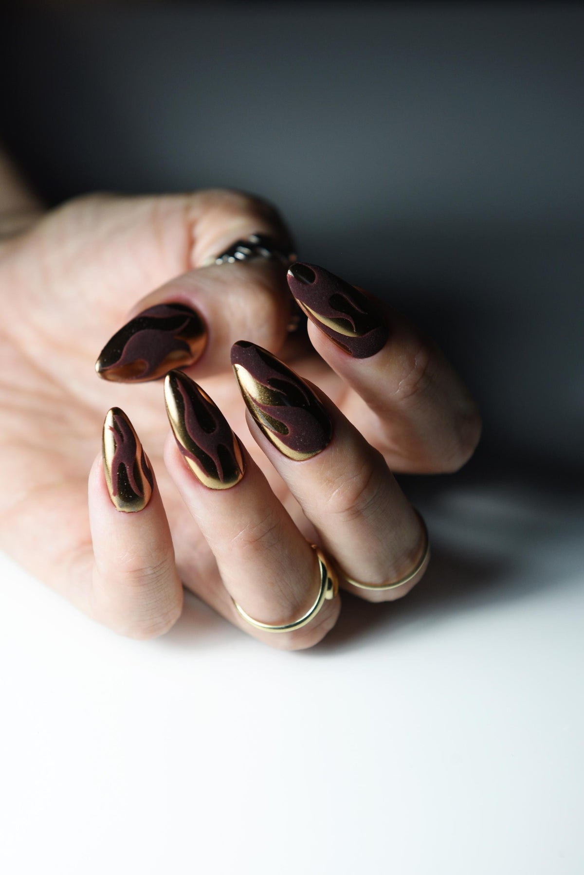 Bronze copper mirror chrome press-on nails with dark matte flame art – detail view