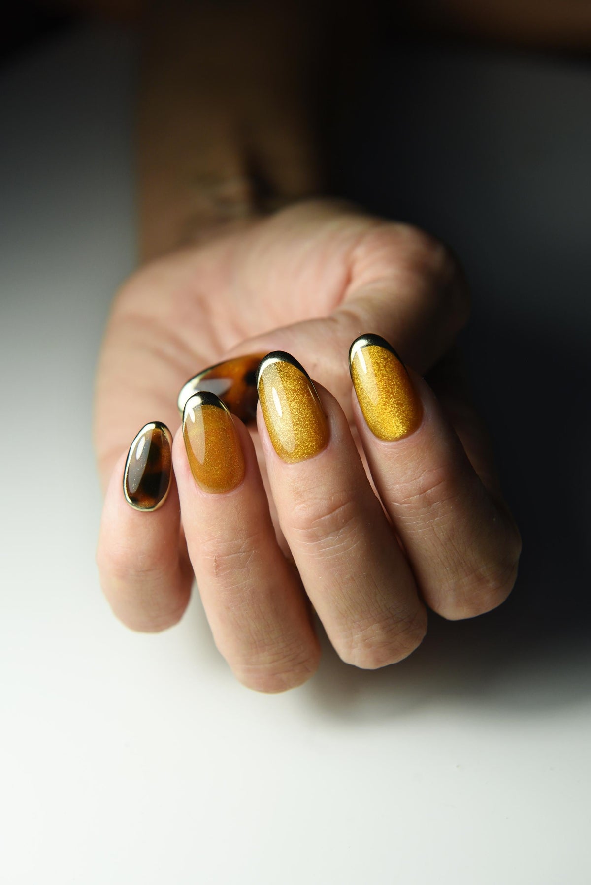 Honey-gold cat-eye press-on nails with tortoise shell accents – detail view