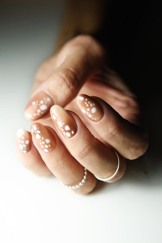 Caramel nude press-on nails with creamy white fawn spots
